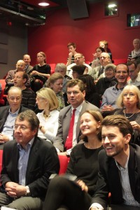 Members of the audience look on smiling