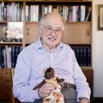 Sir Michael Atiyah holds his Keepsake, a two-headed rag doll